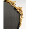 Un miroir mural ou à poser de style Napoléon III en bronze doré et bois noirci. Un miroir mural ou à poser de style Napoléon III en bronze doré et bois noirci.