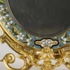 Superbe miroir à poser en bronze à patine dorée à décor émaillé polychrome végétalisant, travail français de la maison Giroux, seconde moitié du XIXe siècle. 